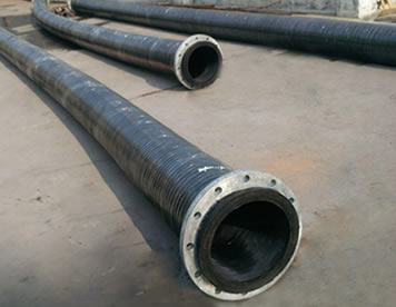 Three sandblast hoses of different lengths are on the ground.