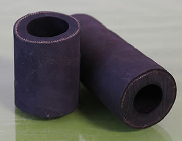 Two sections of military defense sandblast hoses are on the floor.