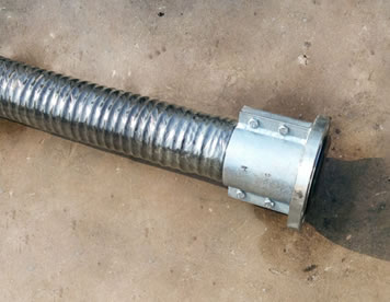A section of sandblast hose assembly is on the ground.